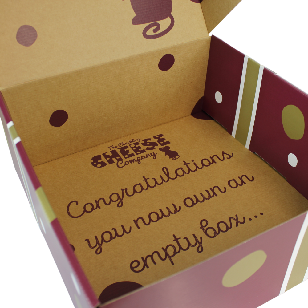 Close-up of the inside of a Chuckling Cheese hamper box with printed gift message.
