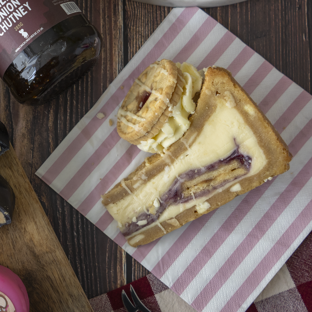 Cookie pie slice with Jamie Dodger, served on a pink striped napkin.