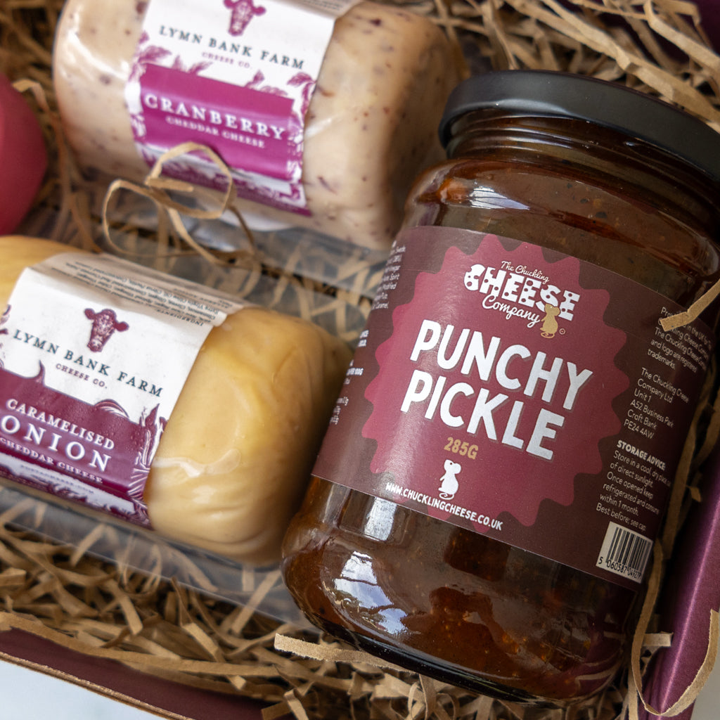 Close-up of Caramelised Red Onion Cheddar and Punchy Pickle in a cheese gift box.