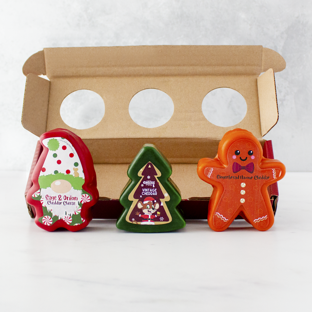 Open Christmas Trio Box #1 red gift box with three festive cheese truckles
