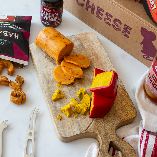 Chuckling Cheese cheese platter with sliced cheddar, red wax cheese, pork scratchings and Reaper’s Revenge chutney