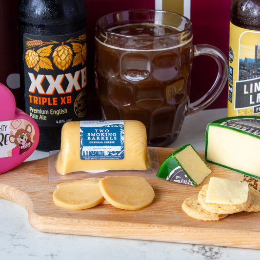 Chuckling Cheese beer and cheese pairing with XXXB beer, Two Smoking Barrels cheddar and sliced cheese