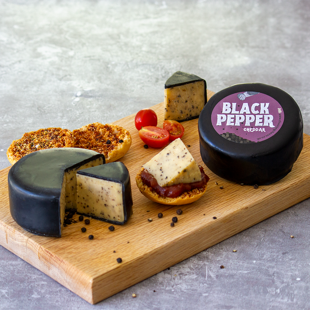 Chuckling Cheese Black Pepper and Charcoal cheddar cheeseboard with crackers and tomatoes