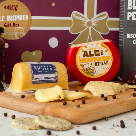 Chuckling Cheese Ale & Mustard Cheddar with Brewer’s Choice cheese, crackers and peppercorns on a wooden board