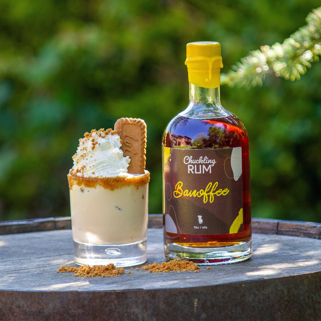 Chuckling Cheese Banoffee Rum bottle with creamy cocktail and biscuit garnish