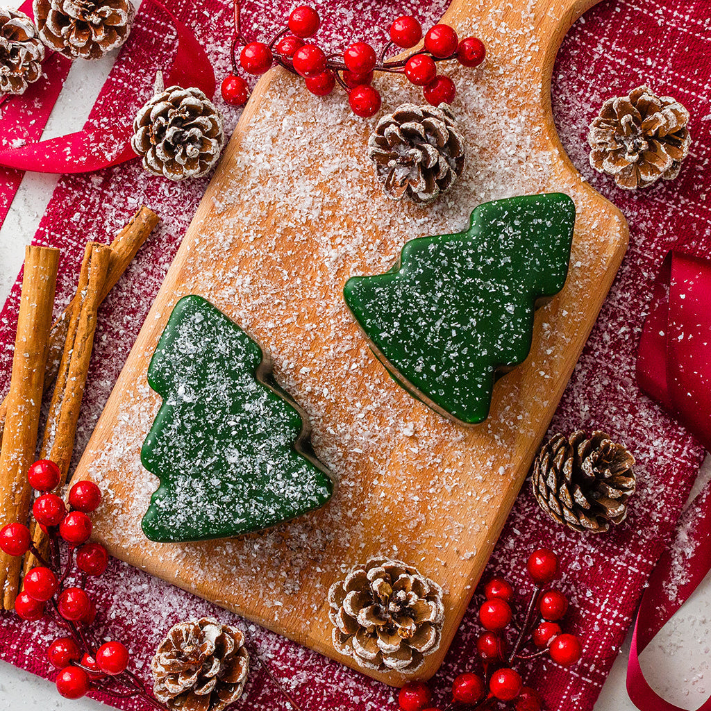 Chuckling Cheese Christmas tree shaped cheddar with festive berries, pinecones and snowy winter styling