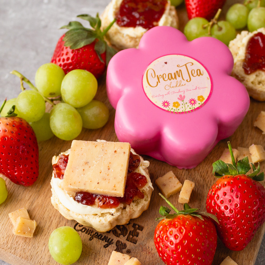 Chuckling Cheese Cream Tea Cheddar Truckle with strawberries, grapes, chutney-topped crackers and sliced cheese