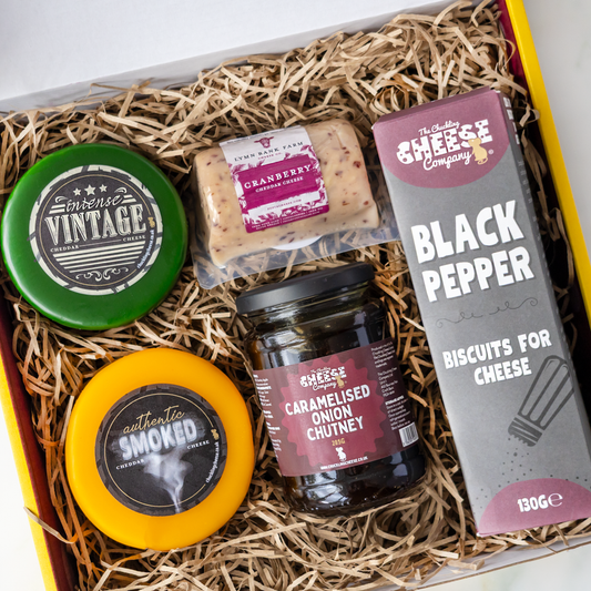 Cheese gift box with Intense Vintage Cheddar, Authentic Smoked Cheddar, Cranberry Cheddar, caramelised onion chutney and Black Pepper biscuits.