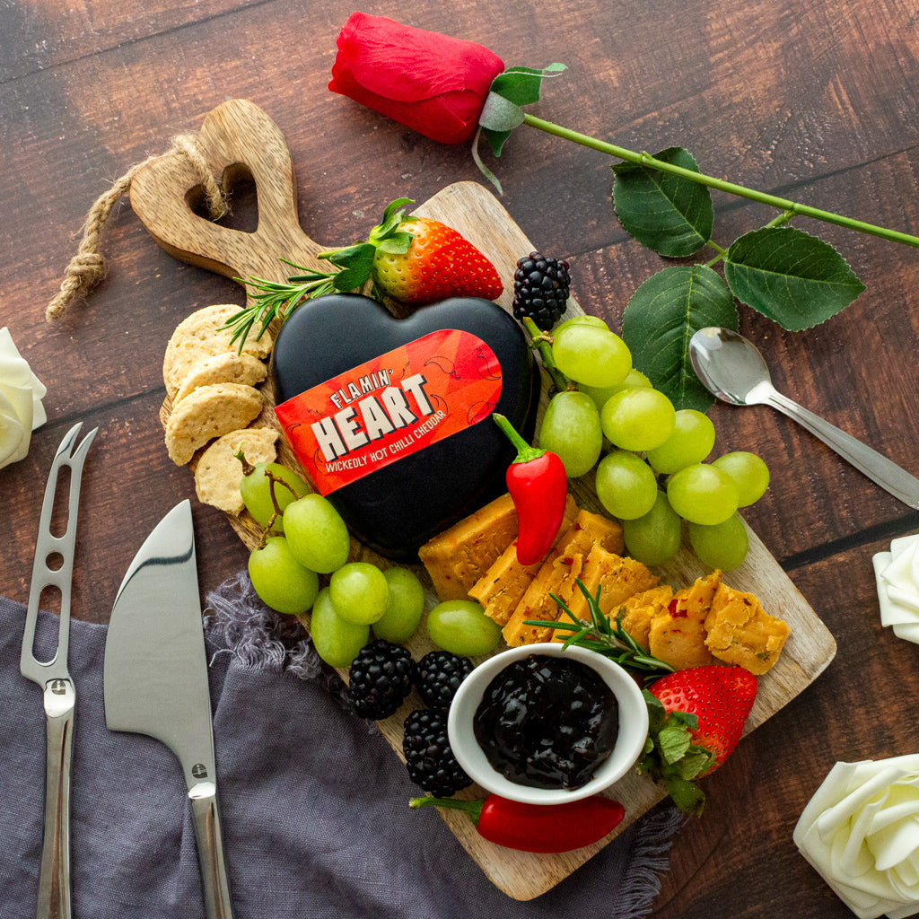 Chuckling Cheese Flamin’ Heart Cheddar cheeseboard with grapes, crackers, chutney and rose
