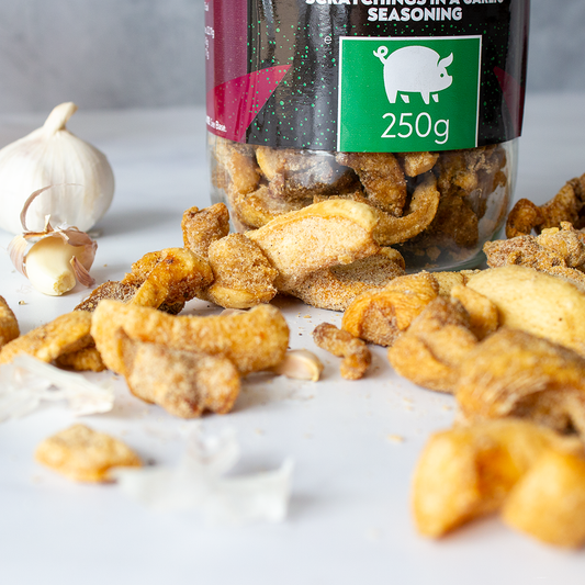 Chuckling Cheese garlic pork scratchings jar with crispy seasoned pork scratchings and garlic cloves
