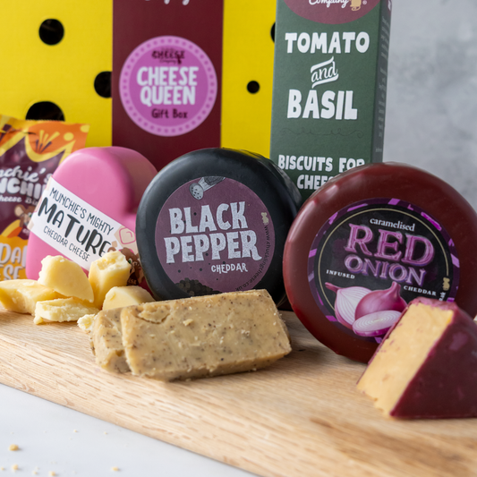 Cheese Queen gift hamper with mature cheddar, black pepper and red onion cheese truckles, plus tomato and basil biscuits
