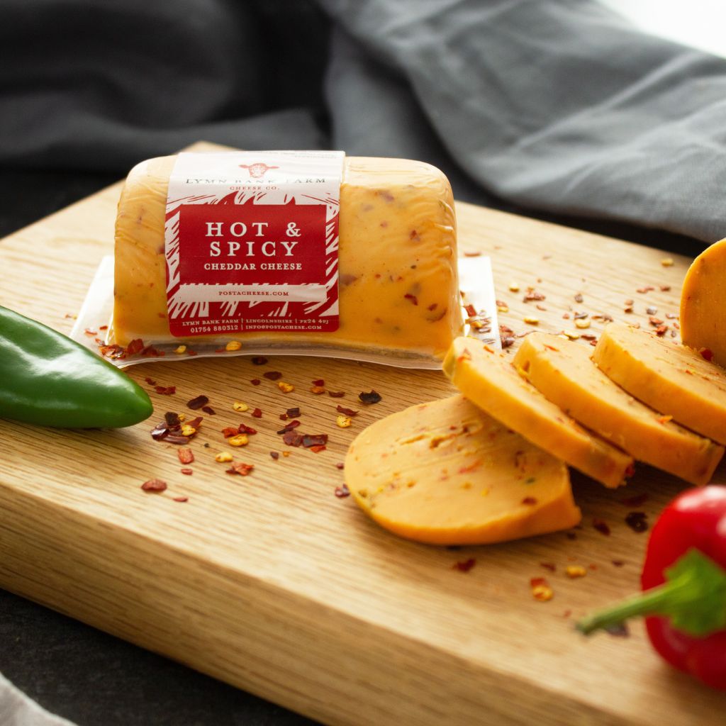 Chuckling Cheese Hot & Spicy Cheddar Barrel with sliced cheese, chilli flakes and peppers
