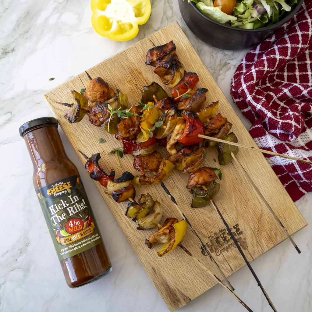 Grilled BBQ chicken skewers served with Kick in the Ribs sauce