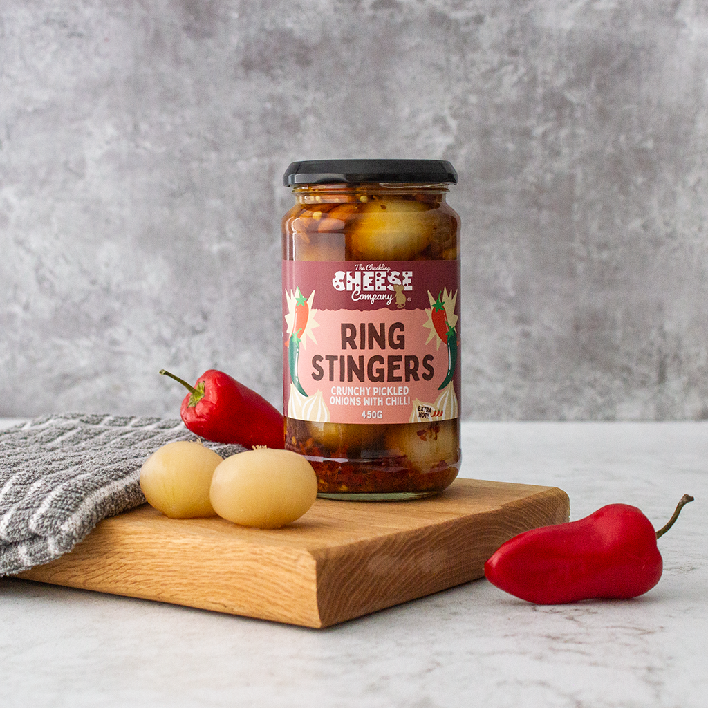 Chuckling Cheese Ring Stingers pickled onions with red chillies on a wooden board