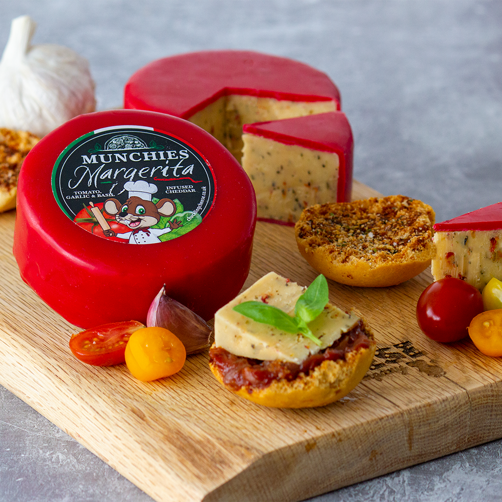 Chuckling Cheese Munchie’s Margherita cheddar truckle with sliced red-wax cheese, garlic, basil, cherry tomatoes and savoury crackers