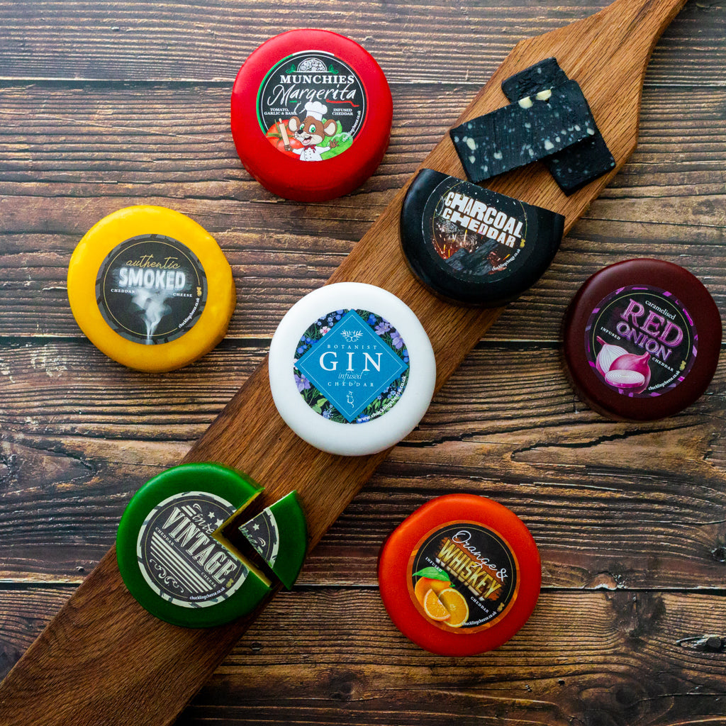 Chuckling Cheese assorted waxed cheese truckles displayed on a wooden board