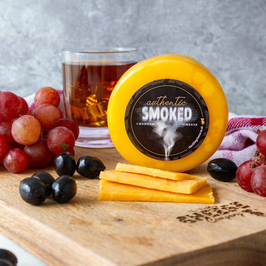 Chuckling Cheese Two Smoking Barrels cheddar with grapes, olives, whisky and sliced cheese