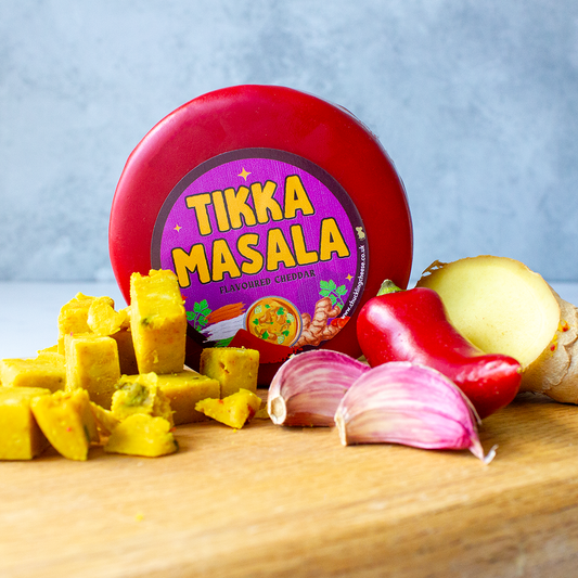 Chuckling Cheese Tikka Masala Cheddar Truckle with sliced cheese, onion, peppers and spices