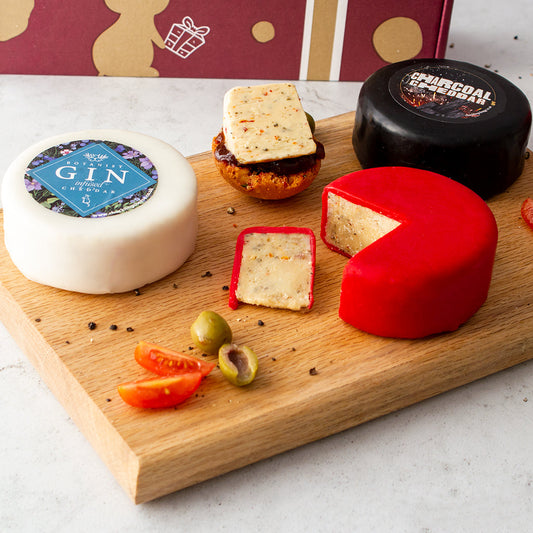 Chuckling Cheese cheeseboard with Gin & Tonic, Charcoal and red waxed cheddar truckles