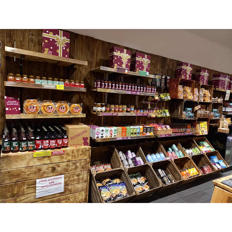 Shelves of artisan cheeses, chutneys, drinks and snacks inside The Chuckling Cheese Company store.