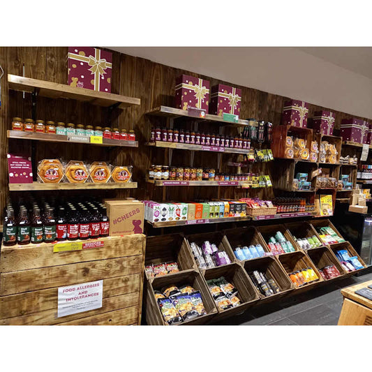 Shelves of artisan cheeses, chutneys, drinks and snacks inside The Chuckling Cheese Company store.