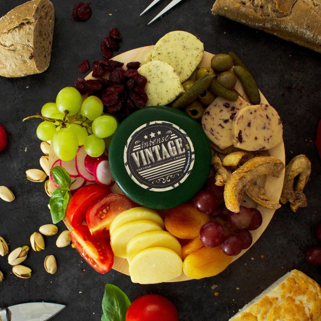Chuckling Cheese Vintage Cheddar Truckle cheeseboard with fruit, crackers, nuts and vegetables