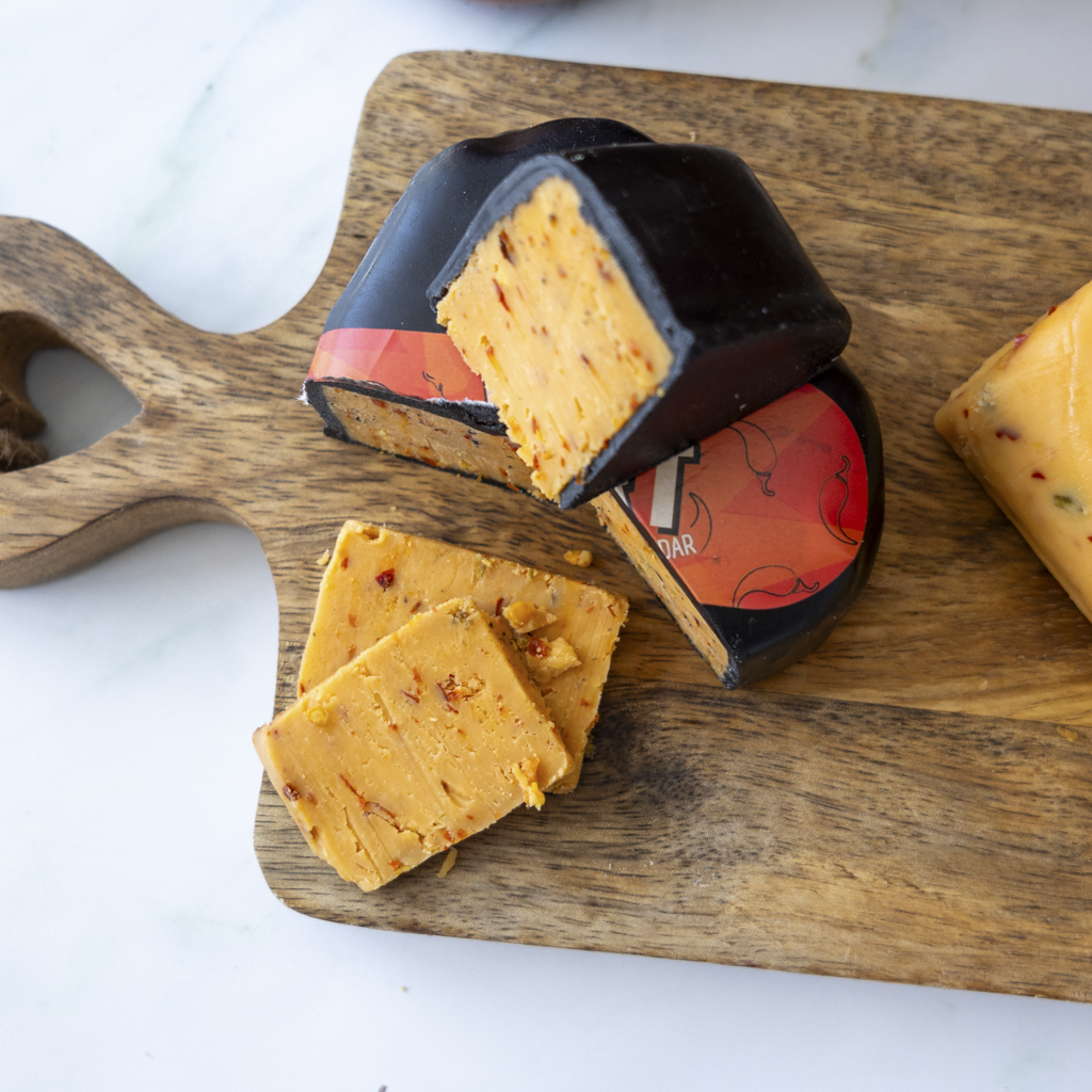 Sliced Flamin’ Heart Cheddar showing spicy orange cheddar texture