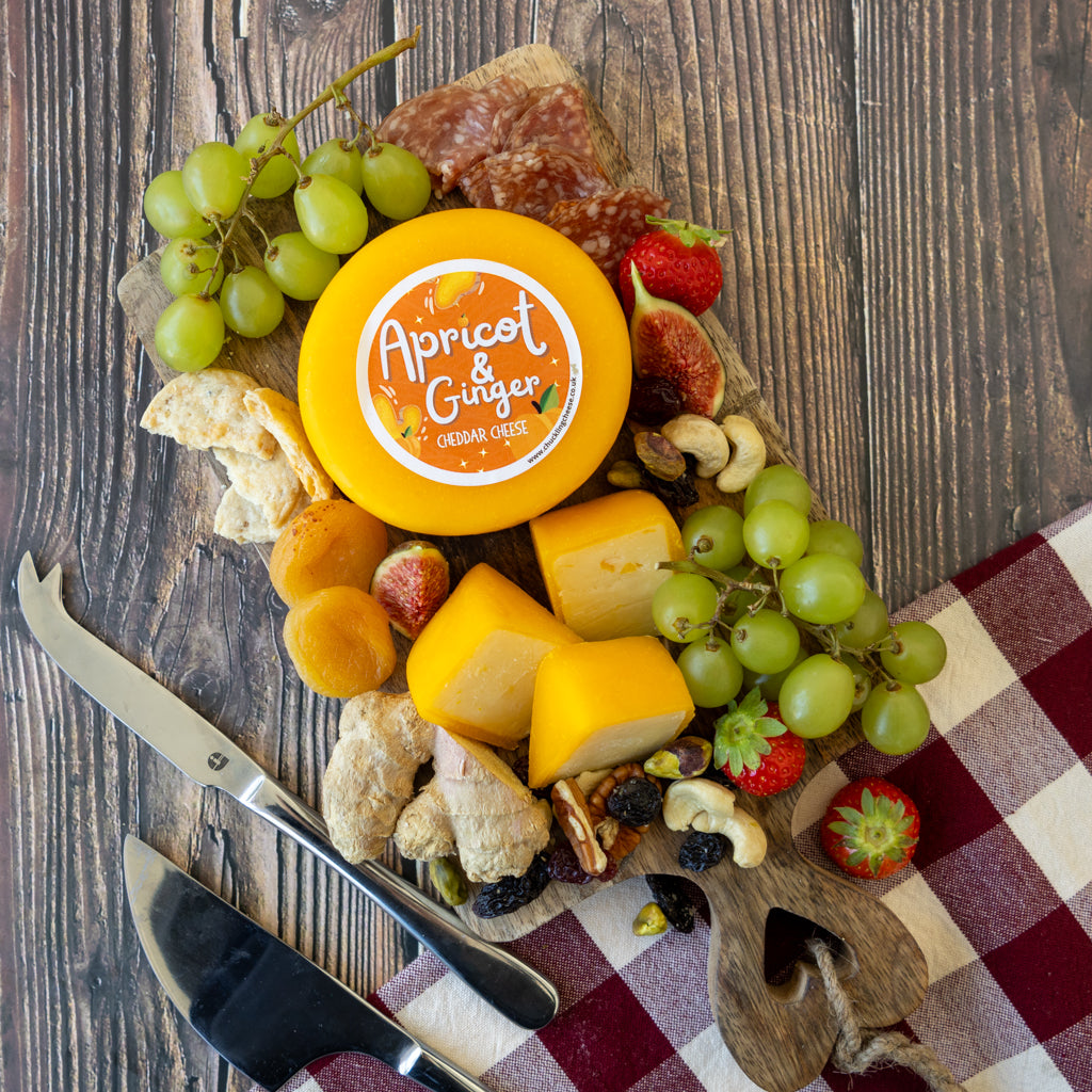 Chuckling Cheese Apricot & Ginger Cheddar Truckle platter with grapes, crackers, dried apricots and cheese slices