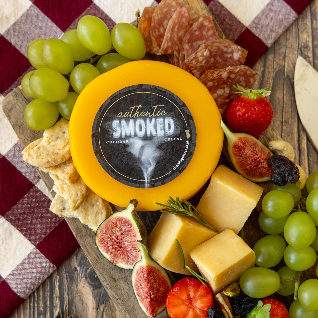 Chuckling Cheese Smoked Cheddar Truckle cheeseboard with grapes, crackers and charcuterie