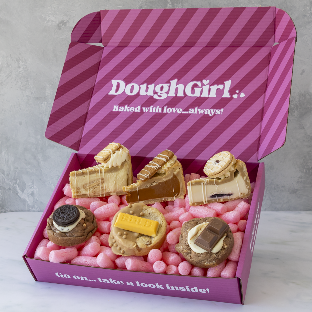 A pink striped gift box labeled 'DoughGirl with cookies and cookie pie slices.