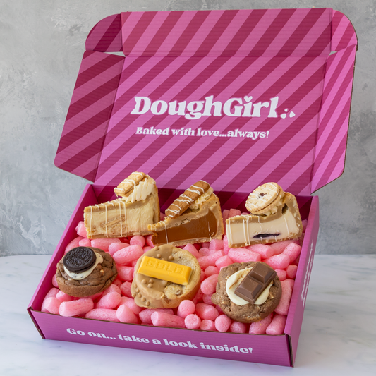 A pink striped gift box labeled 'DoughGirl with cookies and cookie pie slices.