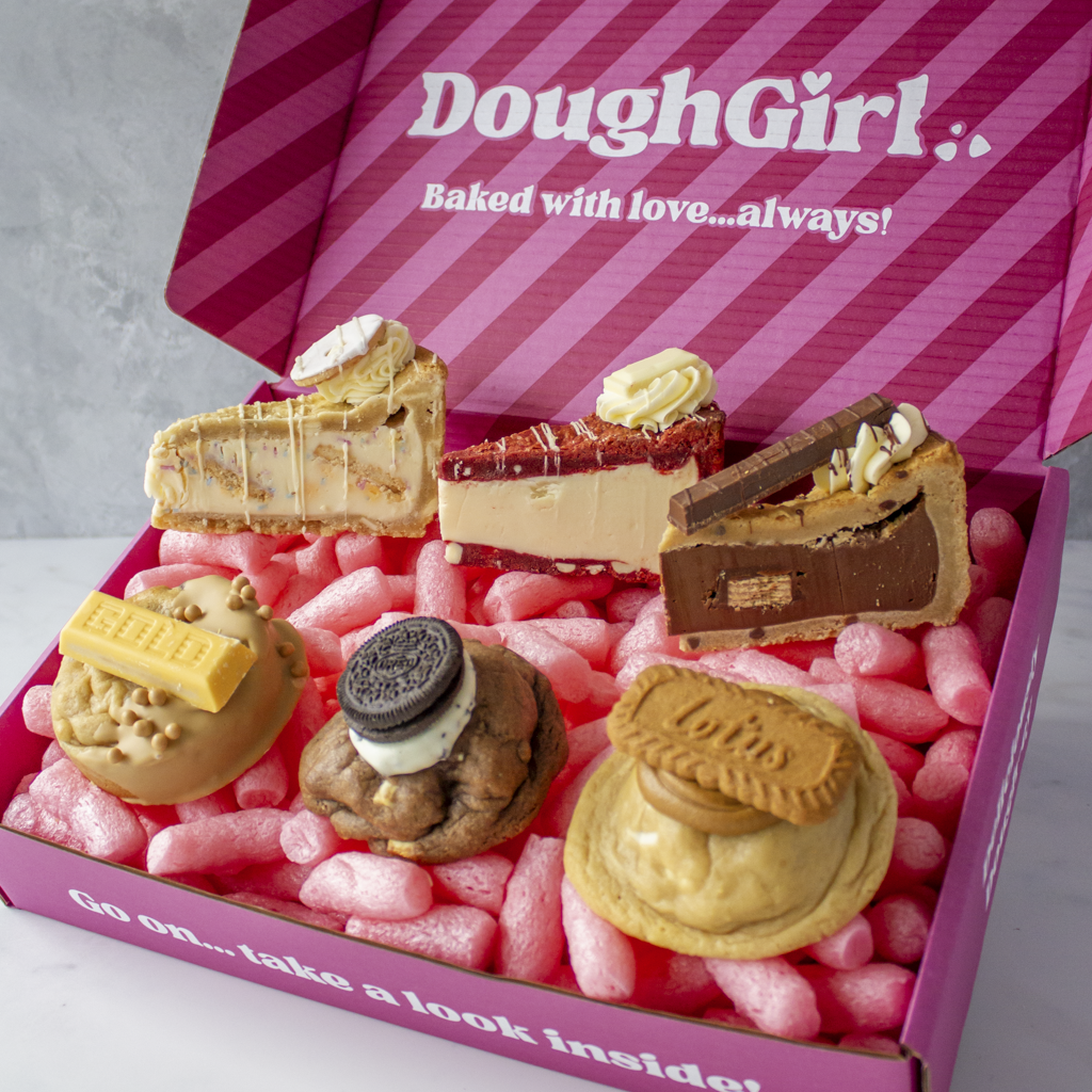 Box of DoughGirl Congratulations Bundle baked goods with 'DoughGirl' branding on a pink striped background.