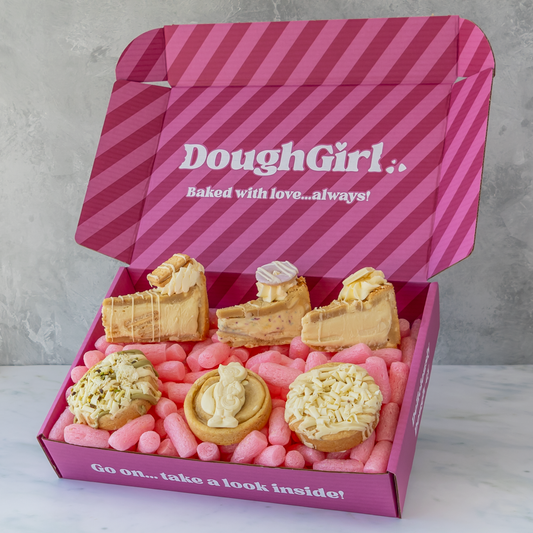 An open pink gift box with diagonal stripes and the text 'DoughGirl.