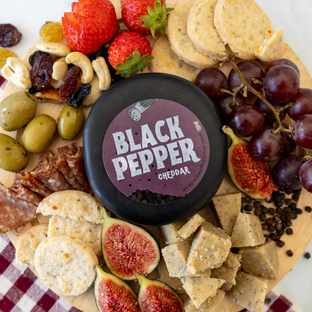 Black Pepper Cheddar Truckle cheeseboard with grapes, crackers, figs and savoury accompaniments