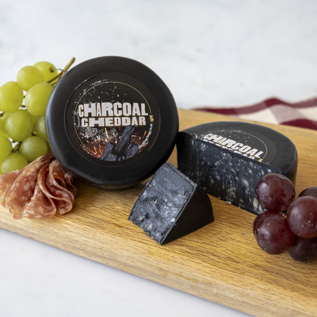 Charcoal Cheddar Truckle with grapes, charcuterie and marbled black cheddar pieces