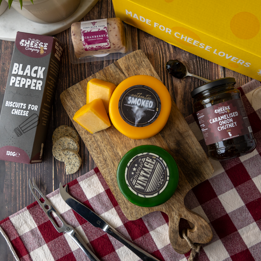 Classic Cheeseboard Gift Box with cheddar cheeses, Black Pepper biscuits, caramelised onion chutney, crackers and cheese cubes.