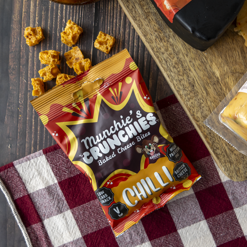 Chilli Munchie’s Crunchies baked cheese bites with spicy cheese gift box products on a wooden board.