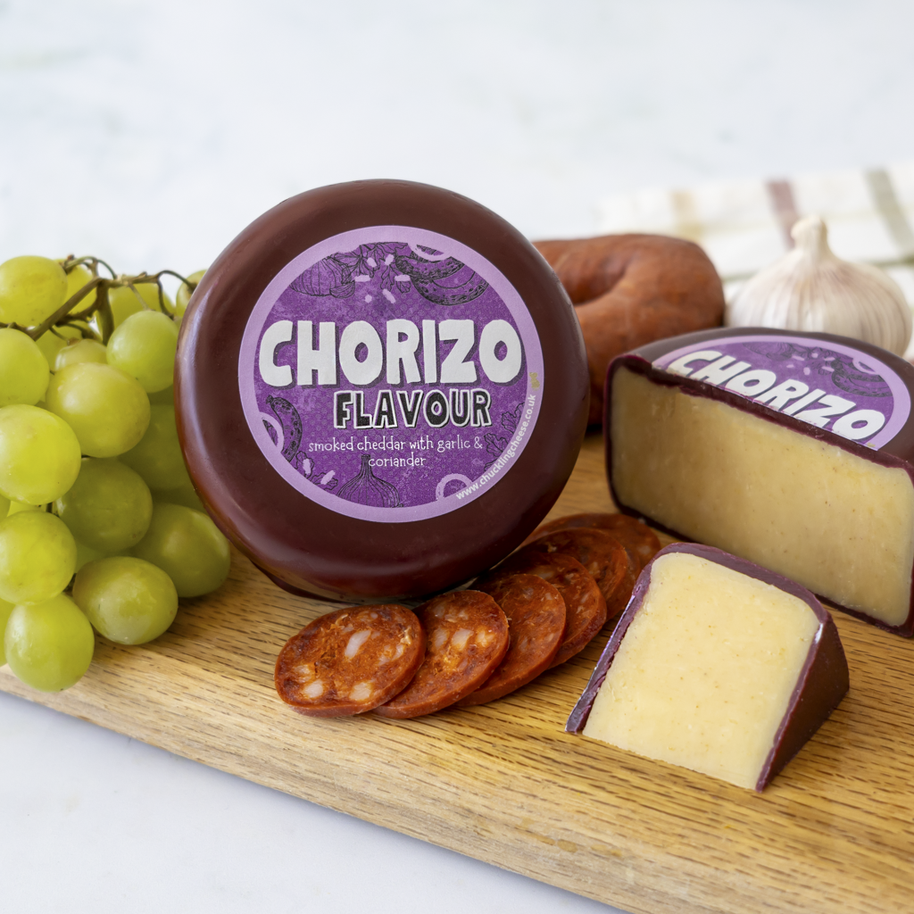 Chuckling Cheese Chorizo Cheddar Truckle with grapes, chorizo slices and cheese wedges