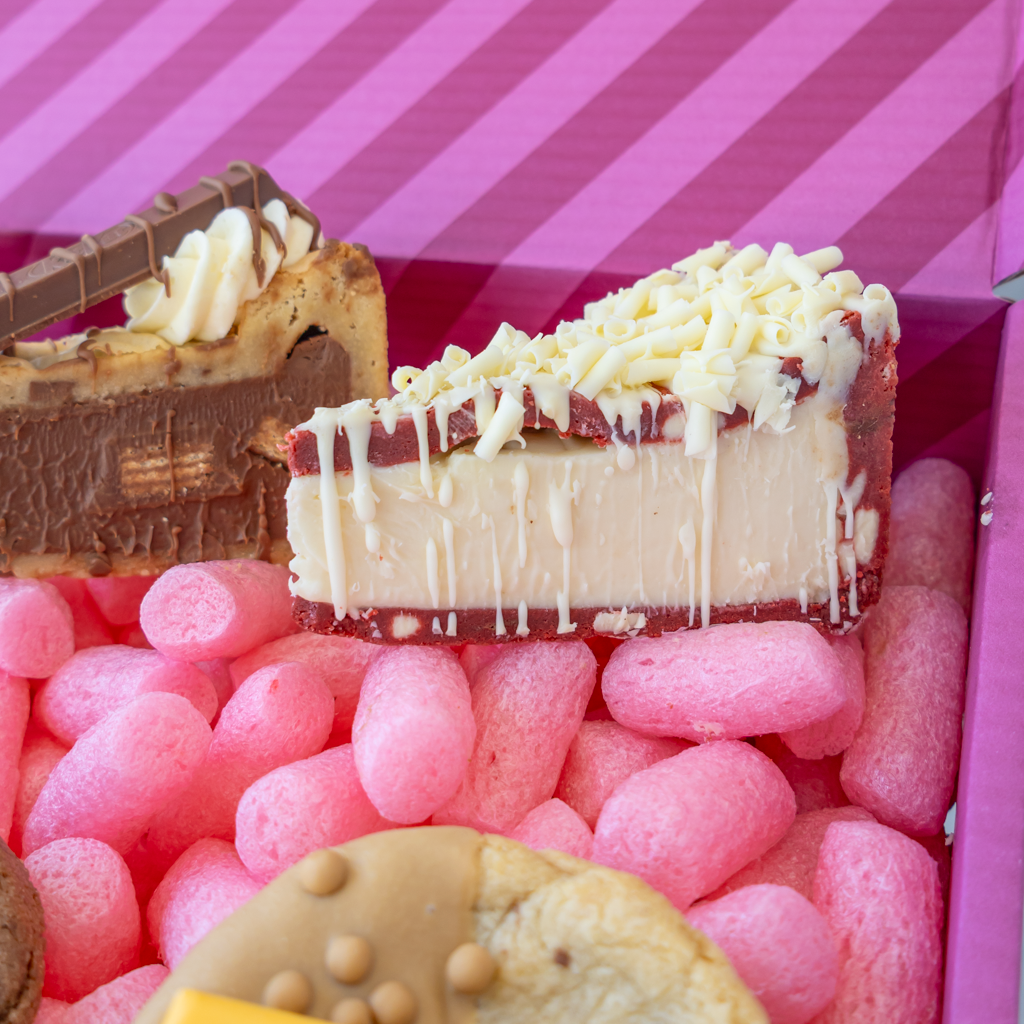 White chocolate-topped cookie pie slices arranged inside the DoughGirl celebration bundle
