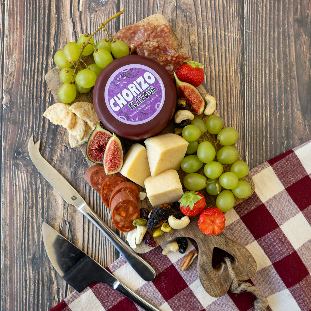 Chorizo Cheddar Truckle cheeseboard with grapes, olives, crackers, charcuterie and cheese cubes