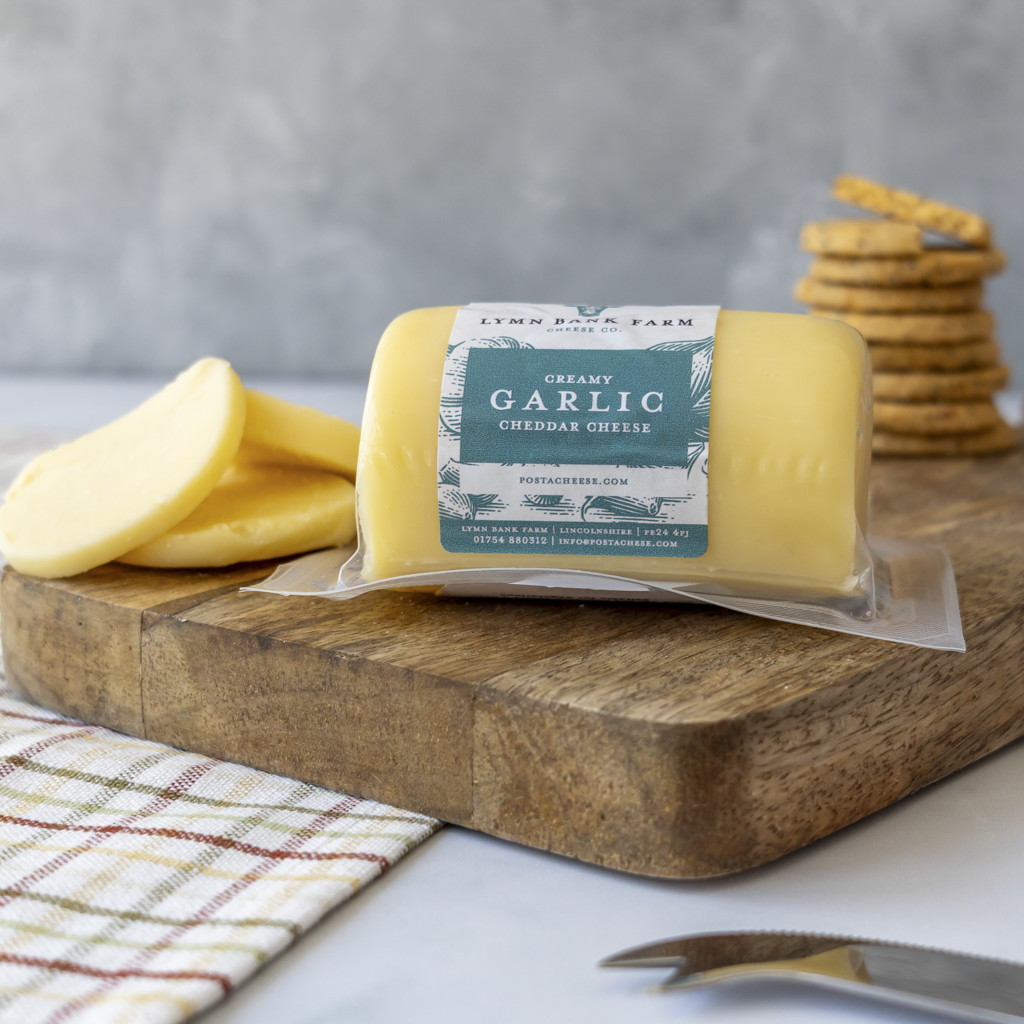 Garlic Cheddar Barrel served with crackers and creamy cheddar slices