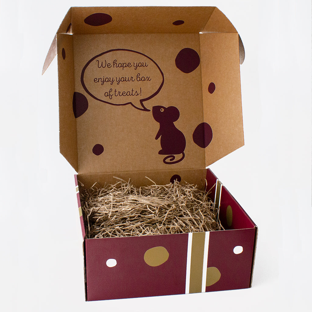 Open empty Chuckling Cheese hamper box showing the decorative interior and gift box base.