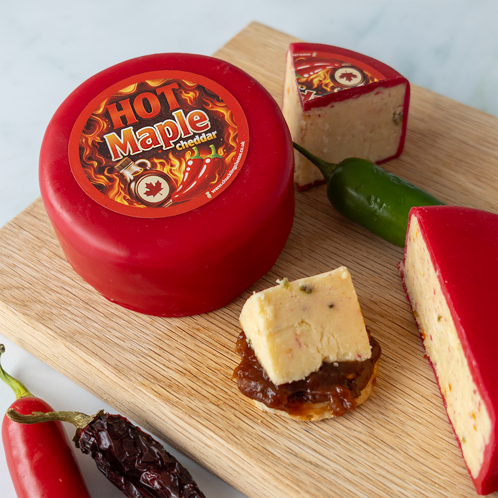 Hot Maple Cheddar Truckle with cut cheddar cube on a serving board