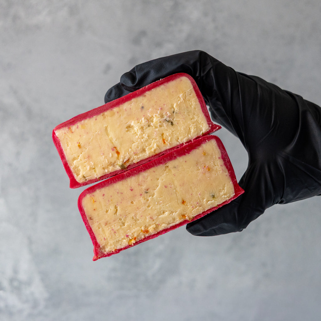 Sliced Hot Maple Cheddar showing creamy mature cheddar with chilli seasoning