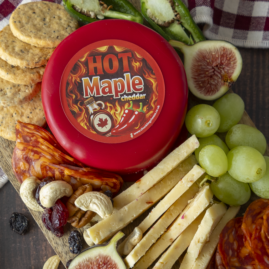 Hot Maple Cheddar Truckle served with grapes, crackers and cheeseboard snacks