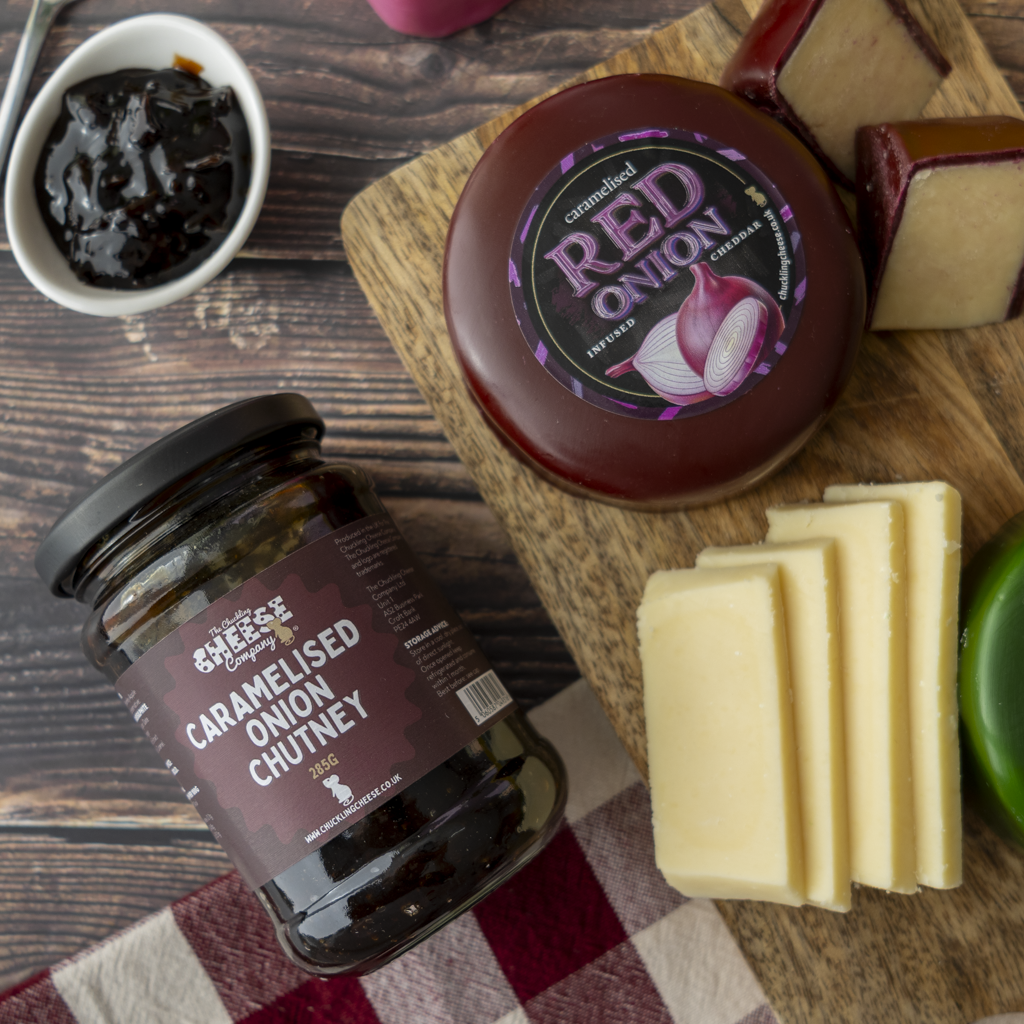 Caramelised Onion Chutney with Caramelised Red Onion Cheddar and sliced cheese on a cheeseboard.