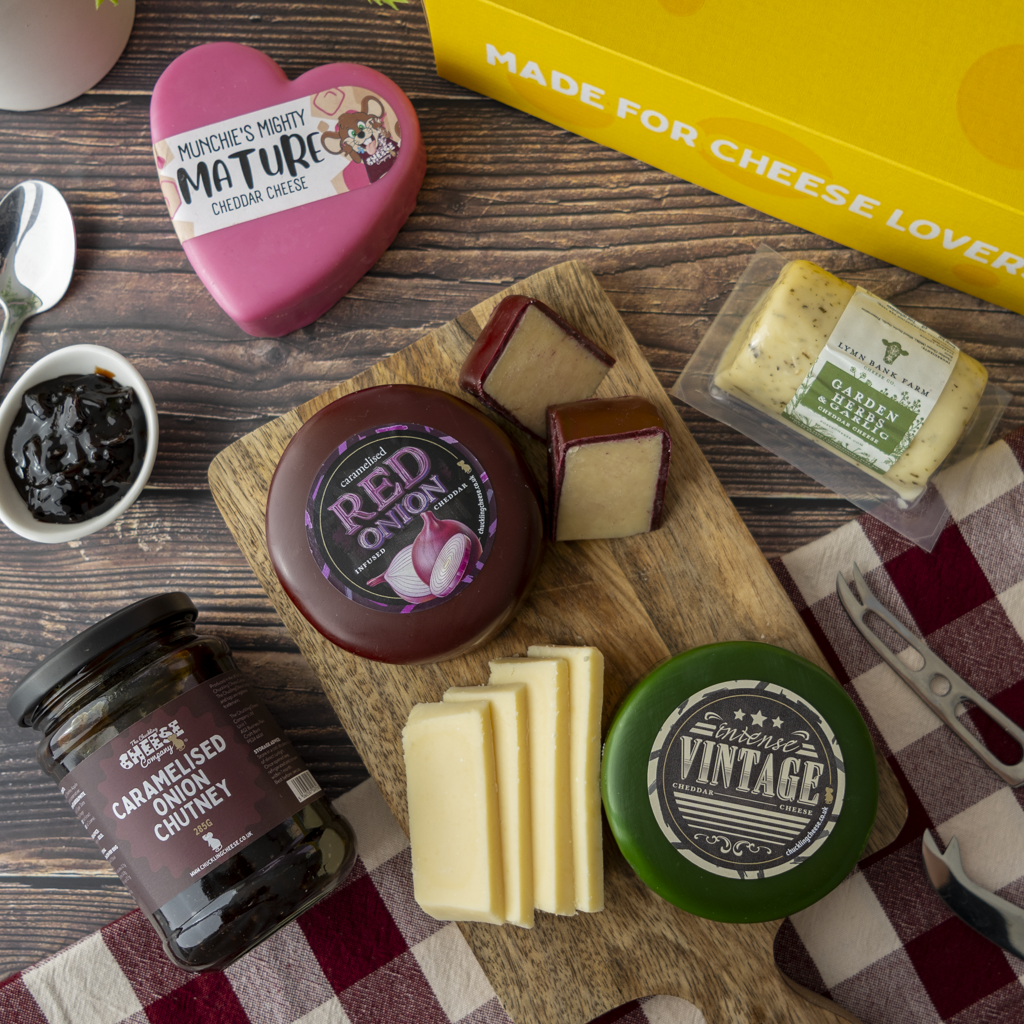 Lincolnshire Gift Box spread with Mighty Mature Cheddar, Caramelised Red Onion Cheddar, Intense Vintage Cheddar, Garden Herbs & Garlic Cheddar and chutney.