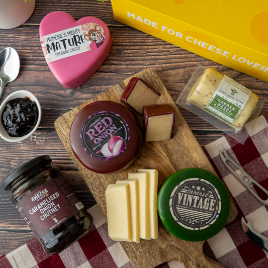 Lincolnshire Gift Box spread with Mighty Mature Cheddar, Caramelised Red Onion Cheddar, Intense Vintage Cheddar, Garden Herbs & Garlic Cheddar and chutney.