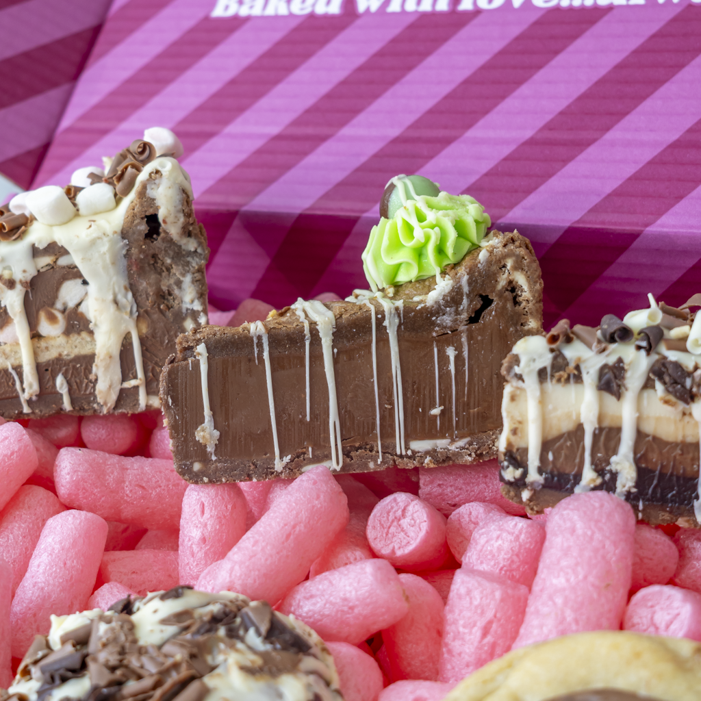 Selection of milk chocolate cookie pies and stuffed cookies inside a pink gift box