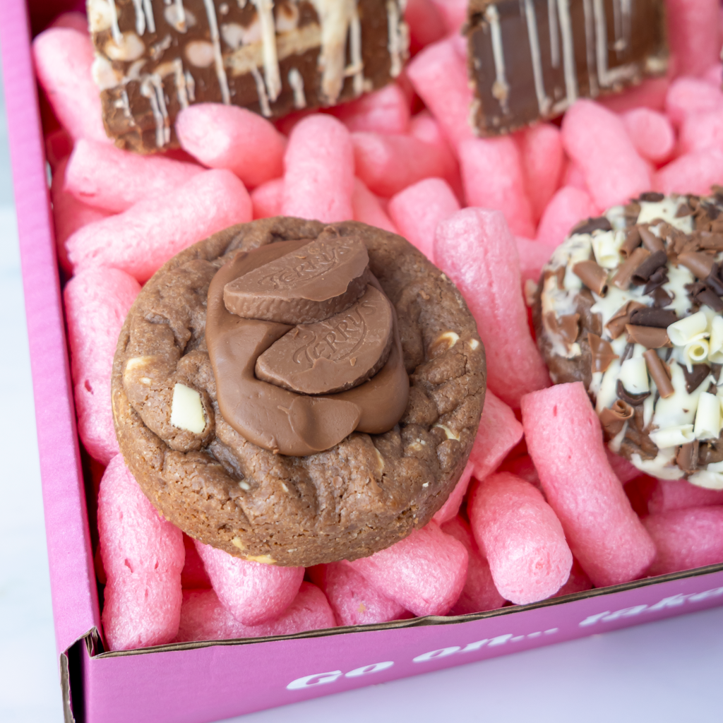 Close-up of thick chocolate deluxe cookies and decorated cookie pie slices